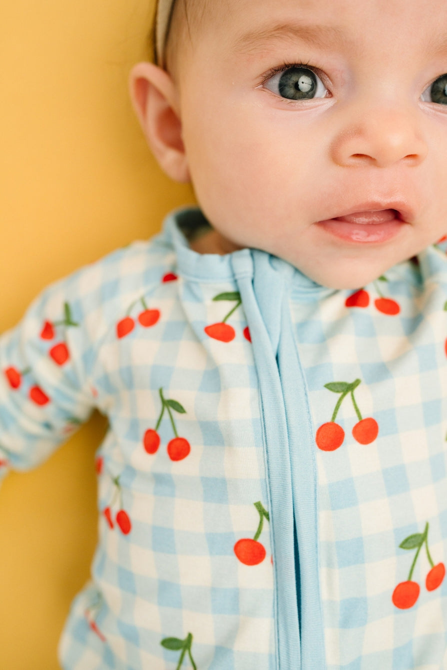 baby girl 2 way zip footie with blue plaid and cherry print