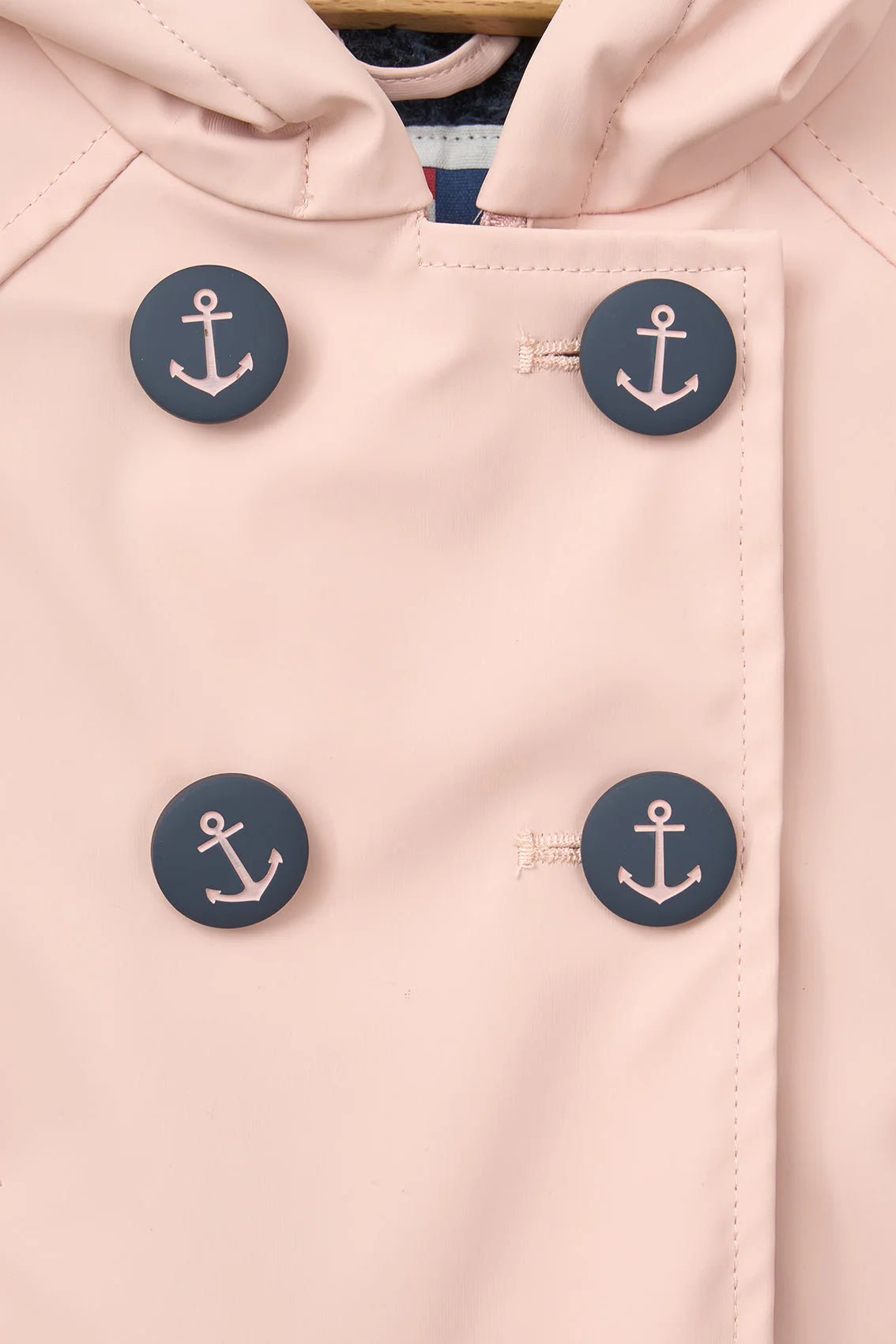 pink infant raincoat with anchor buttons